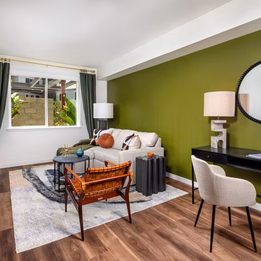 Spacious living room featuring modern decor and large windows in Paloma Apartments