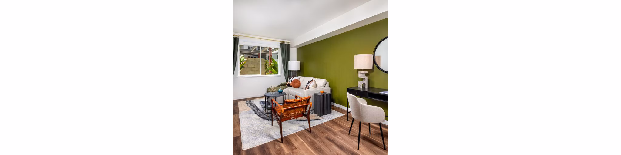 Spacious living room featuring modern decor and large windows in Paloma Apartments