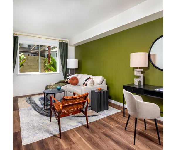 Spacious living room featuring modern decor and large windows in Paloma Apartments