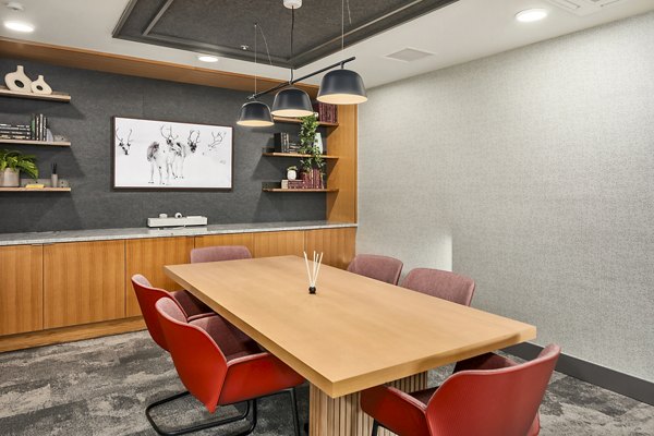 Clubhouse meeting facility with modern seating and large table at Broadstone Strata Apartments for luxury gatherings and events