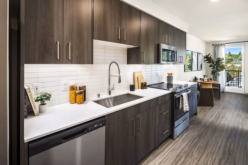 Modern kitchen with stainless steel appliances in Broadstone Strata Apartments