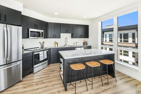 Modern kitchen with stainless steel appliances at Broadstone Strata Apartments