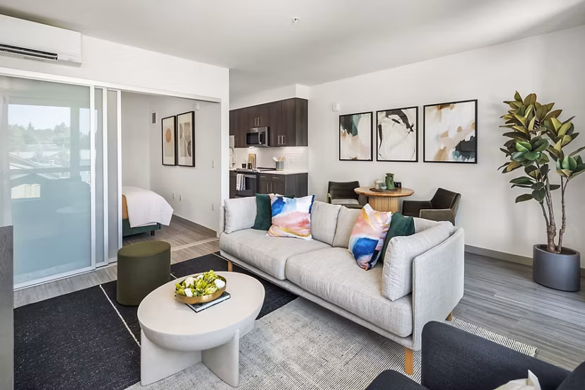 Modern living room with sleek furnishings and natural light at Broadstone Strata, downtown luxury apartments