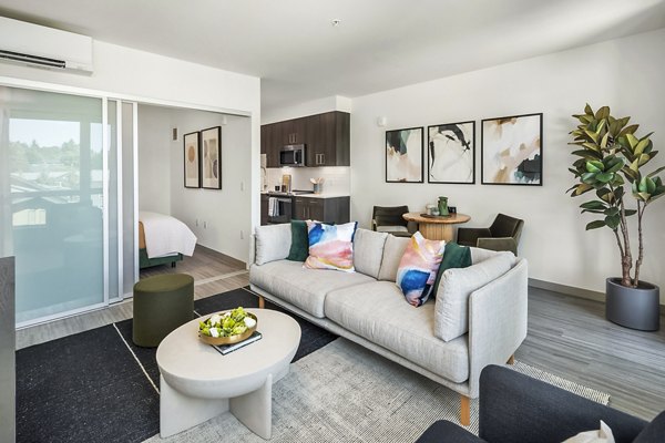 Modern living room with sleek furnishings and natural light at Broadstone Strata, downtown luxury apartments
