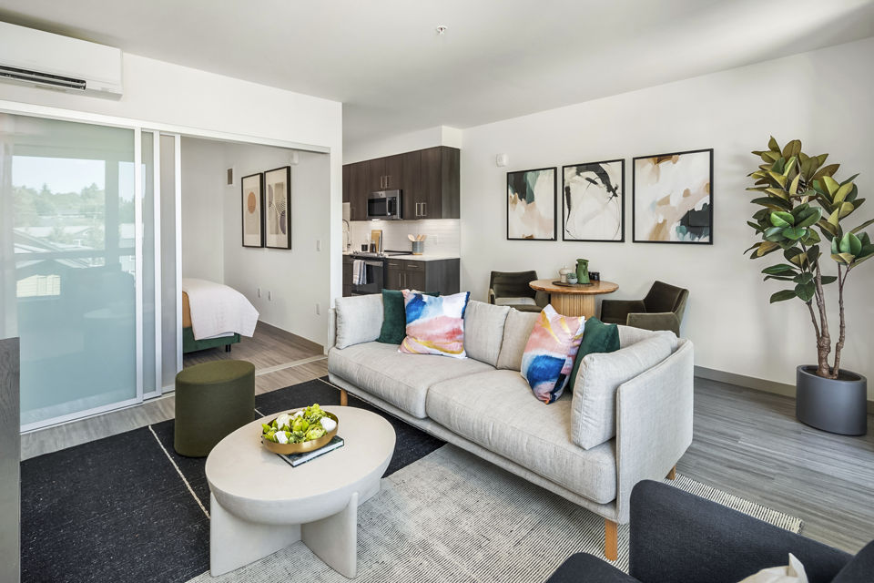 Modern living room with sleek furnishings and natural light at Broadstone Strata, downtown luxury apartments