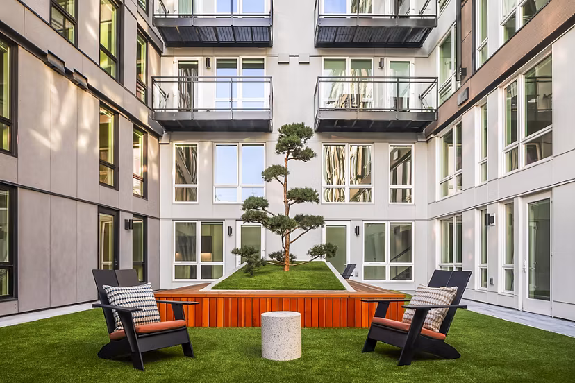 Courtyard patio with modern furniture at Broadstone Strata Apartments, luxury living space enhancing outdoor relaxation in an upscale setting