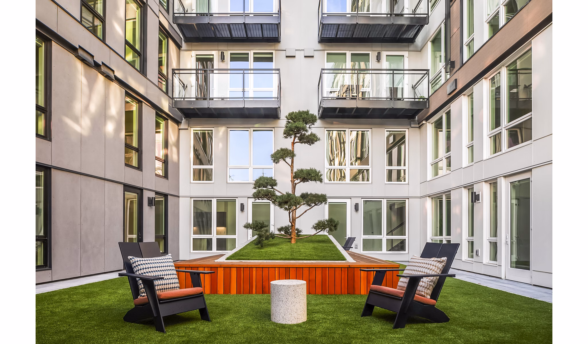 Courtyard patio with modern furniture at Broadstone Strata Apartments, luxury living space enhancing outdoor relaxation in an upscale setting
