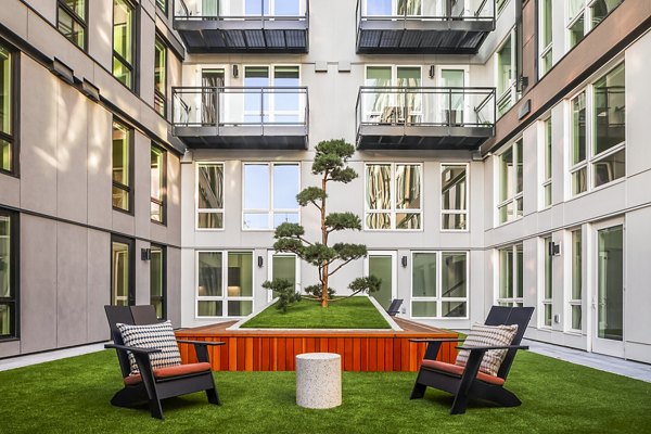Courtyard patio with modern furniture at Broadstone Strata Apartments, luxury living space enhancing outdoor relaxation in an upscale setting