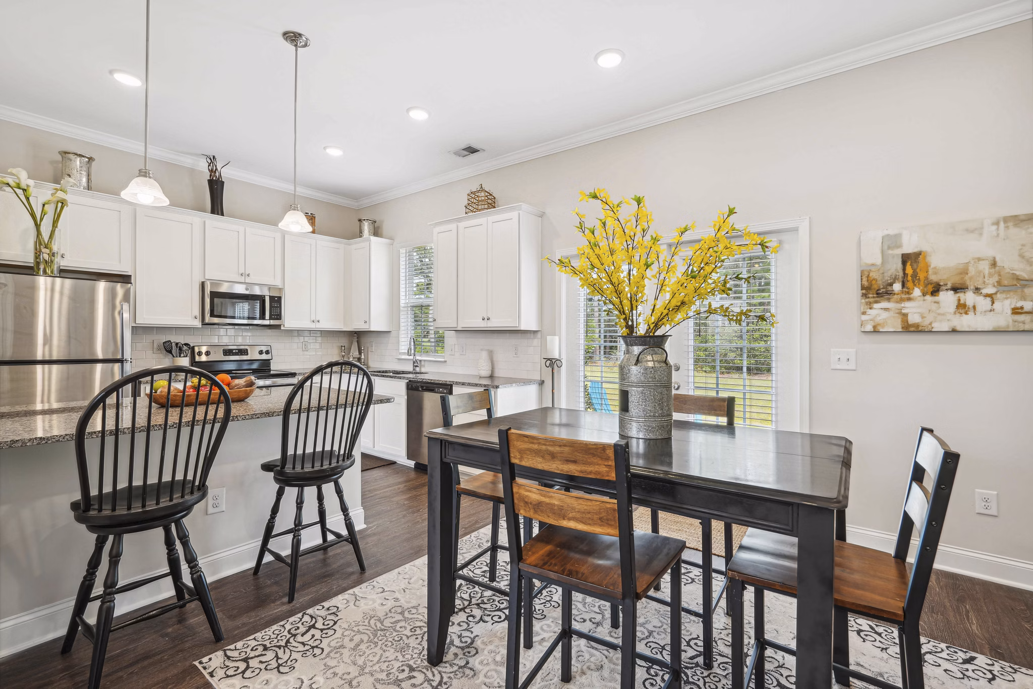 Dining area with cozy seating and modern lighting at Ailsa Village Apartments, offering luxury living in a serene environment