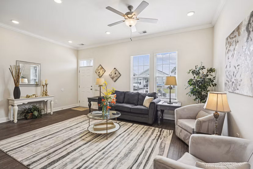 Living room with modern decor and large windows at Ailsa Village Apartments