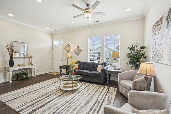 Living room with modern decor and large windows at Ailsa Village Apartments