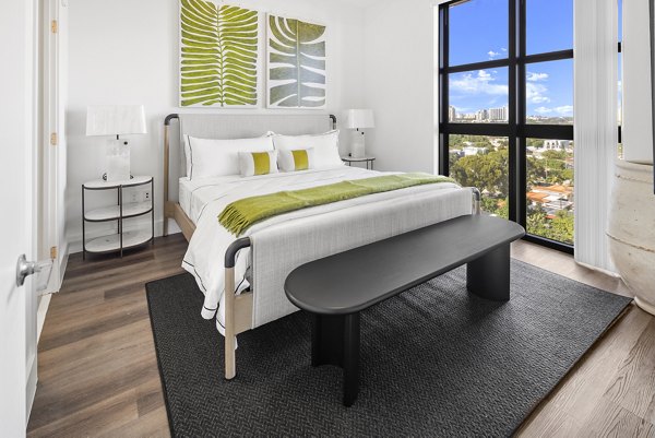 Modern bedroom with cozy bedding in Grove Central Residences Apartments
