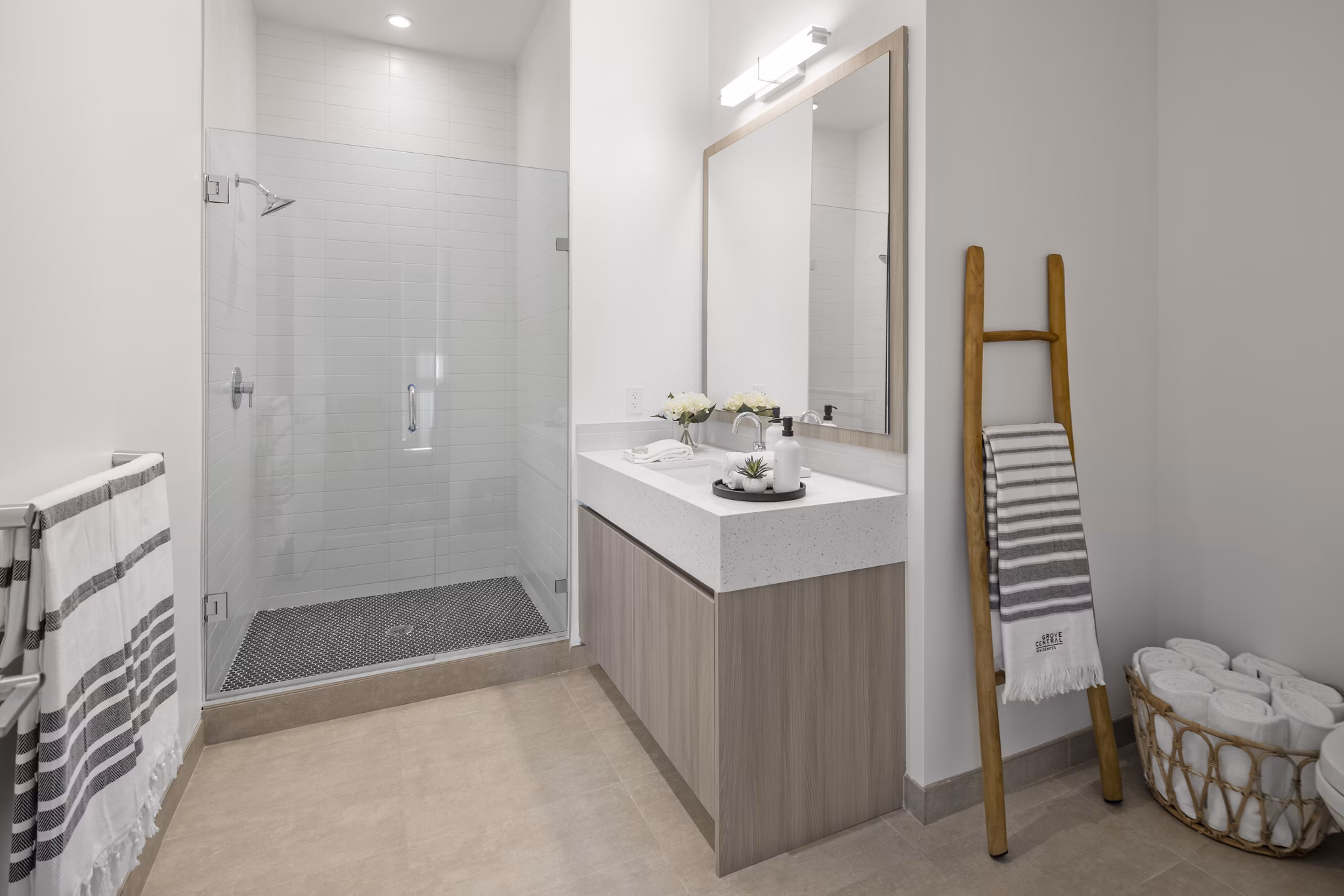 Bathroom featuring modern fixtures and marble countertops in Grove Central Residences Apartments