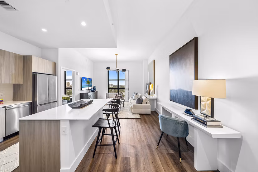 Modern kitchen with granite countertops and stainless steel appliances in Grove Central Residences Apartments