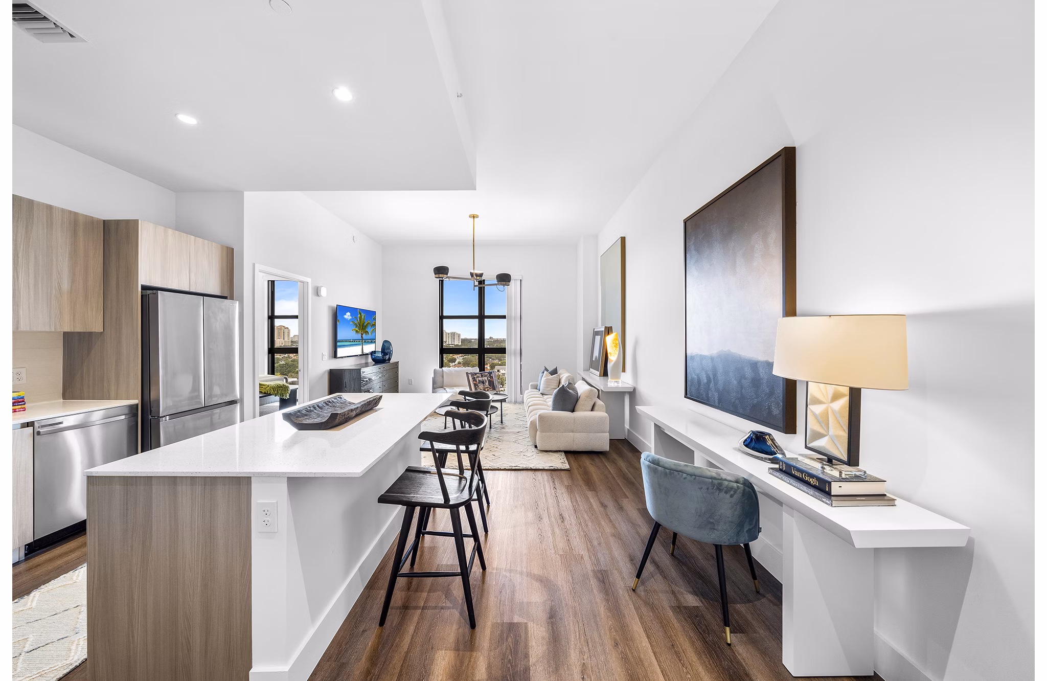 Modern kitchen with granite countertops and stainless steel appliances in Grove Central Residences Apartments