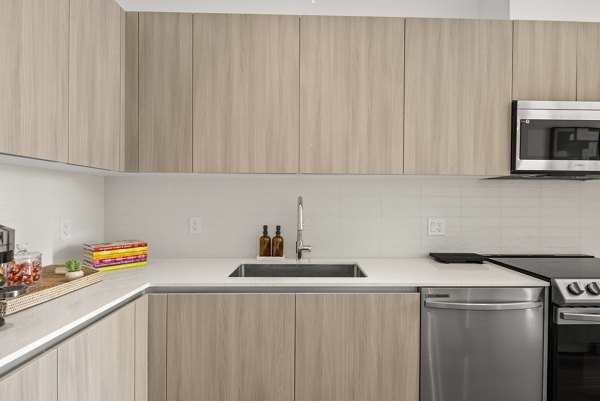 Modern kitchen featuring sleek countertops and stainless steel appliances at Aventura Bellevue Apartments