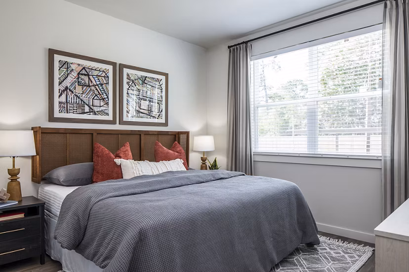 Cozy bedroom featuring a comfortable bed and framed artwork in luxury apartments
