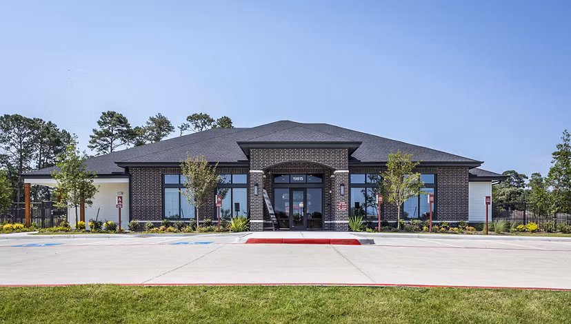 Modern luxury apartments with landscaped area in front, showcasing upscale living