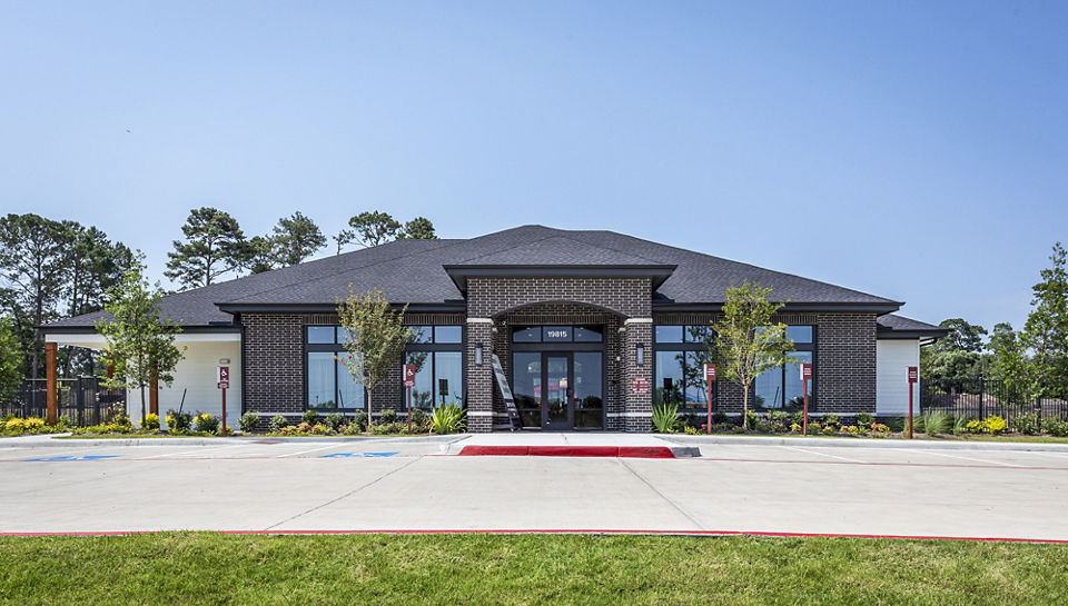 Modern luxury apartments with landscaped area in front, showcasing upscale living