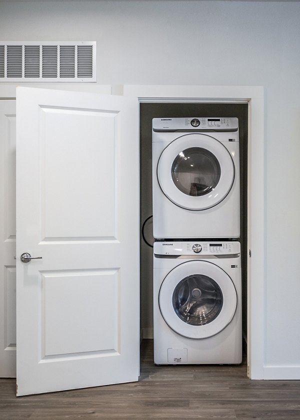 Convenient stacked washer and dryer in a luxury apartment closet