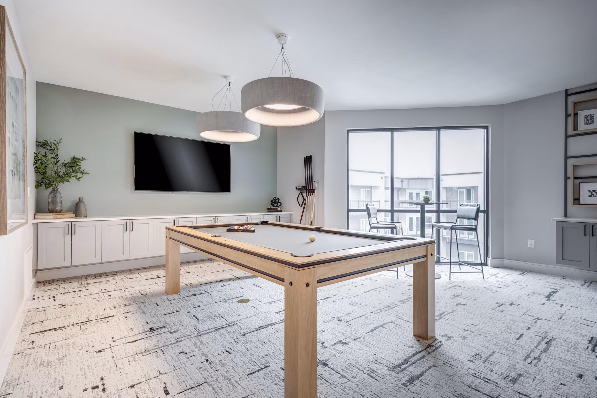 Game room with pool tables and lounge seating at Prospect Apartments