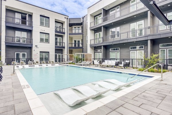 Resort-style pool with lounge chairs at Prospect Apartments