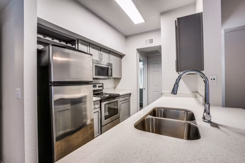 Kitchen featuring modern appliances at Oak Crest Apartments