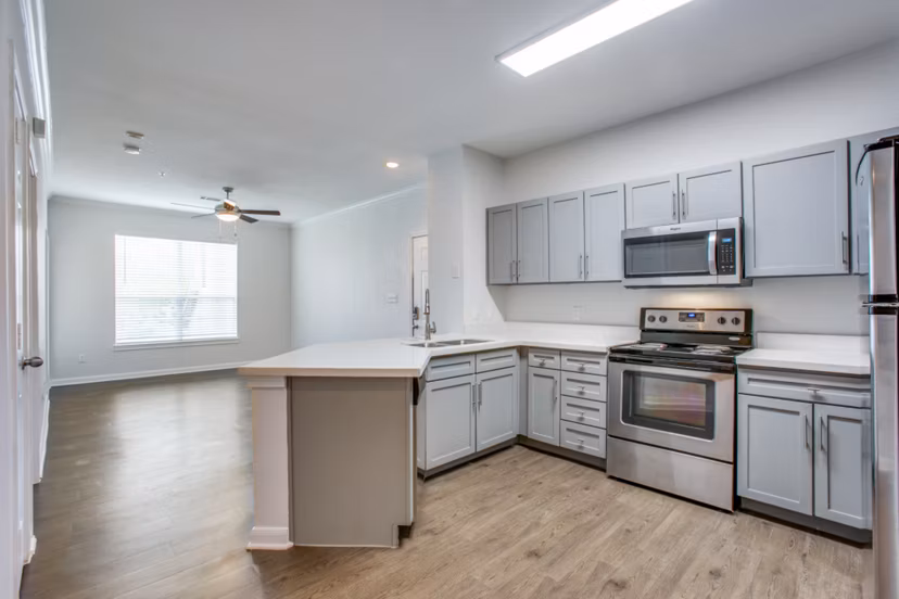 Oak Crest Apartments: Modern kitchen with stainless steel appliances and sleek countertops at luxury apartments in prime location