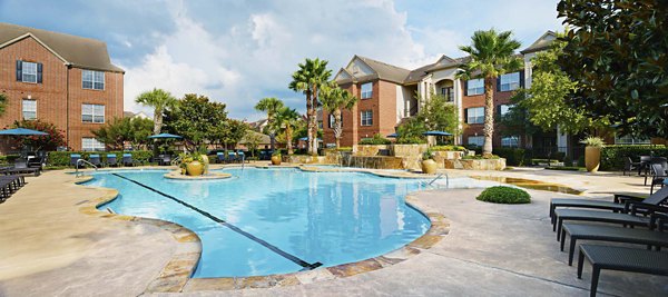 Relaxing resort-style pool at Oak Crest Apartments offering luxury amenities and serene surroundings for upscale living
