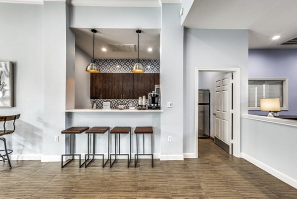 Clubhouse with plush seating and entertainment area at Woodland Park Apartments, offering a luxurious social space for residents