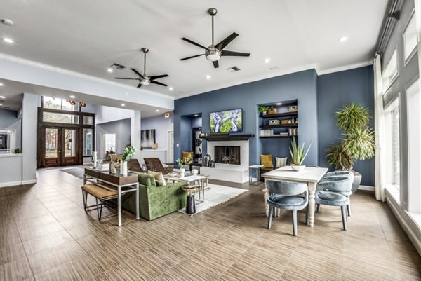 Clubhouse featuring modern furnishings and entertainment space at Woodland Park Apartments