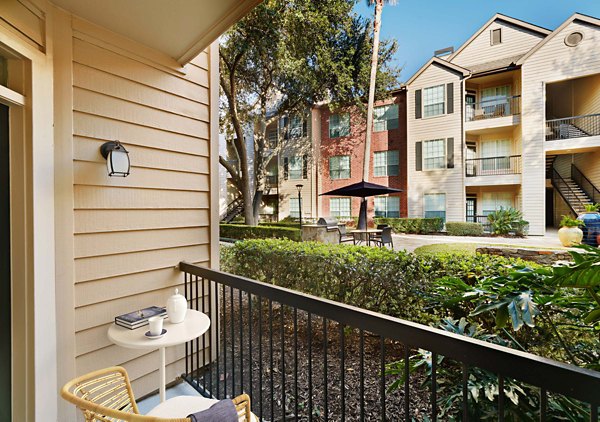Patio with modern outdoor seating at Woodland Park Apartments, perfect for relaxing or entertaining in a luxurious Greystar community