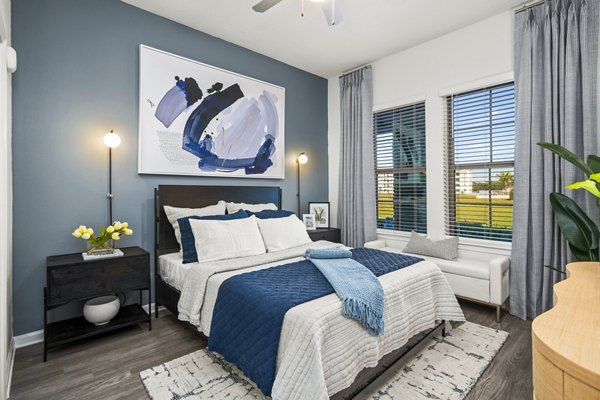 Sanctuary at Daytona Apartments: Elegant bedroom with plush furnishings and serene decor