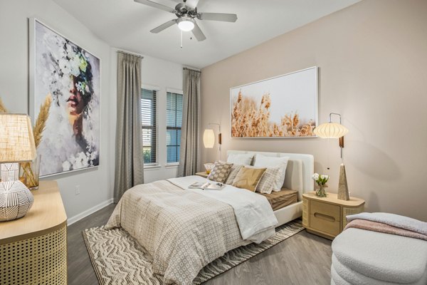 Sanctuary at Daytona Apartments: Cozy bedroom with modern decor and ample natural light