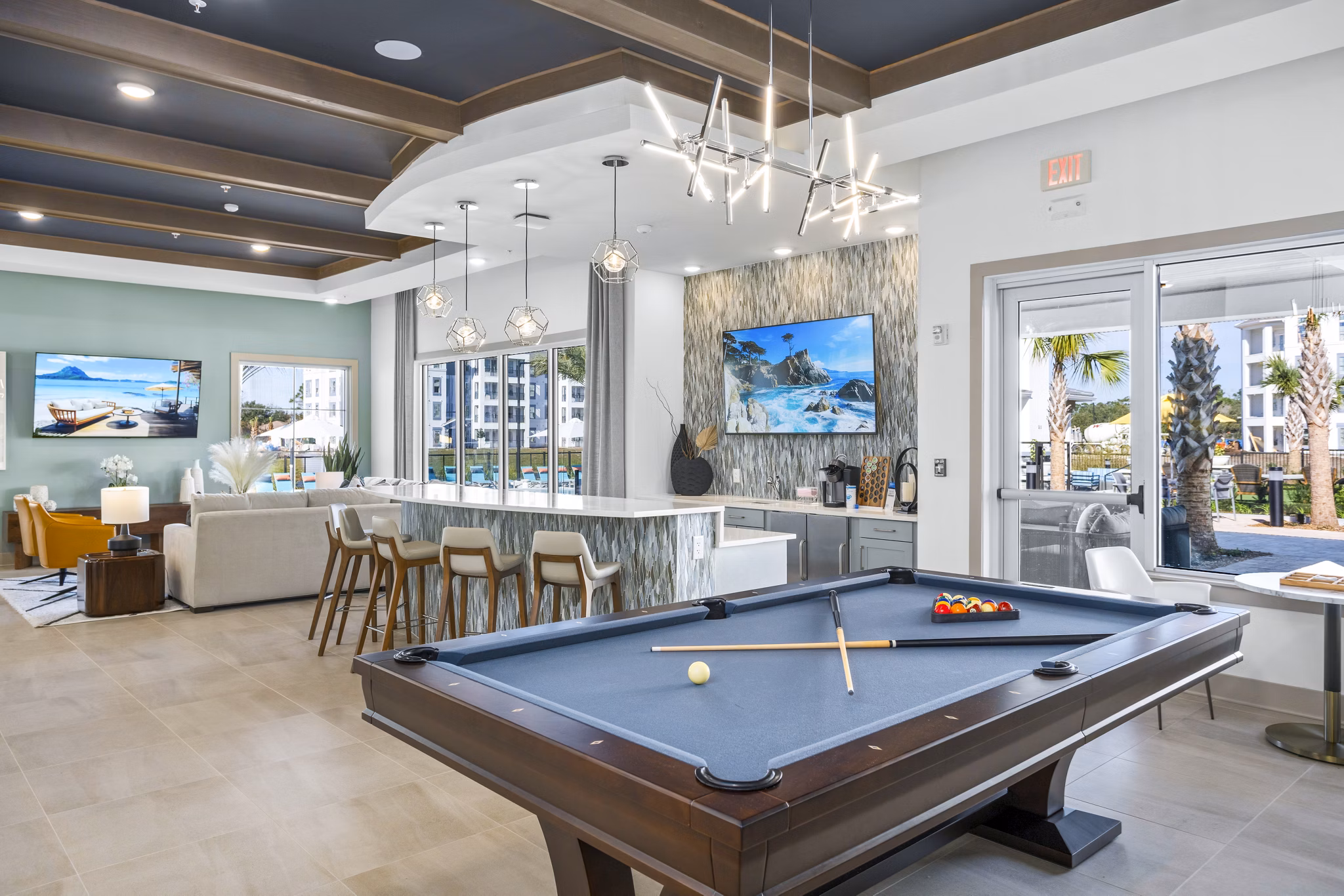 Clubhouse game room with billiards and lounge seating at Sanctuary at Daytona Apartments