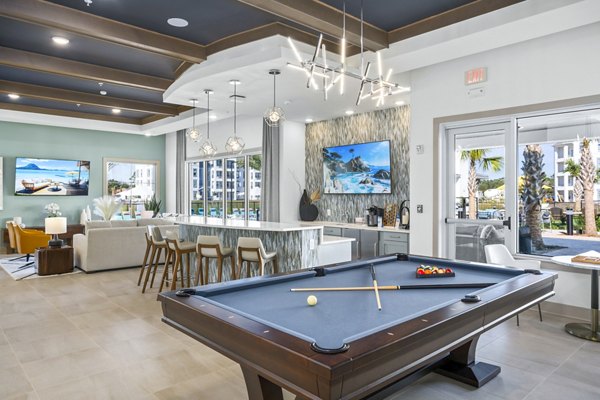 Clubhouse game room with billiards and lounge seating at Sanctuary at Daytona Apartments