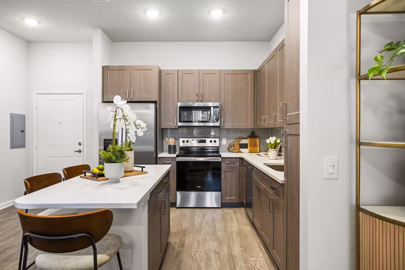 Modern kitchen with stainless steel appliances at Sanctuary at Daytona Apartments