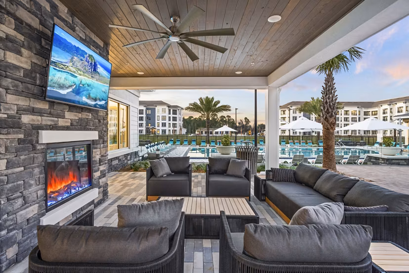 Cozy patio with fire pit at Sanctuary at Daytona Apartments, offering luxurious outdoor living experiences