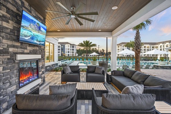 Cozy patio with fire pit at Sanctuary at Daytona Apartments, offering luxurious outdoor living experiences