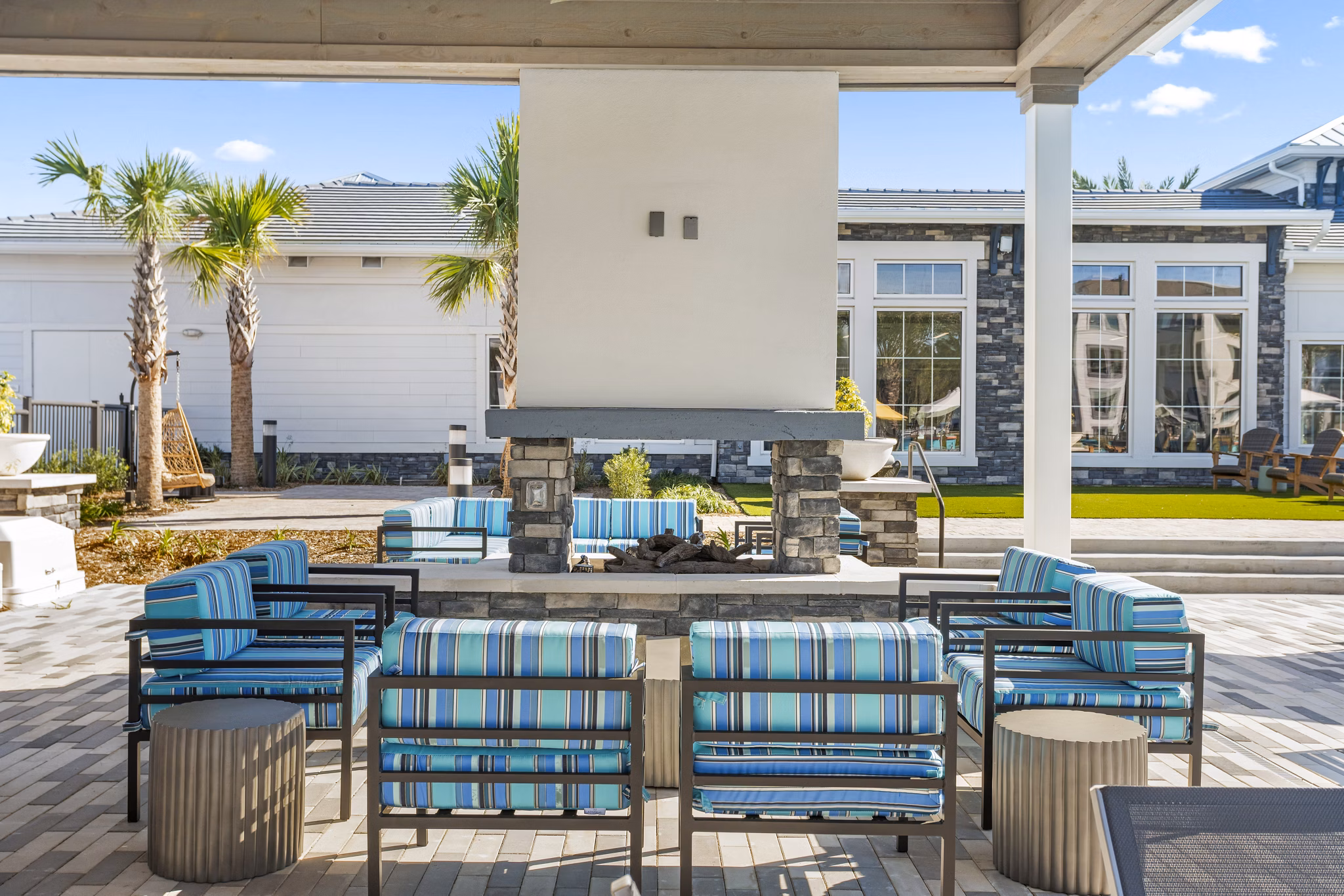 Fire pit and patio seating area at Sanctuary at Daytona Apartments: luxury outdoor amenity for relaxation and social gatherings