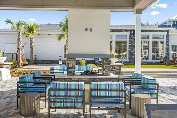 Fire pit and patio seating area at Sanctuary at Daytona Apartments: luxury outdoor amenity for relaxation and social gatherings