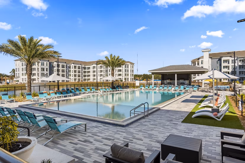 Infinity-edge pool at Sanctuary at Daytona Apartments with tranquil surroundings and modern design