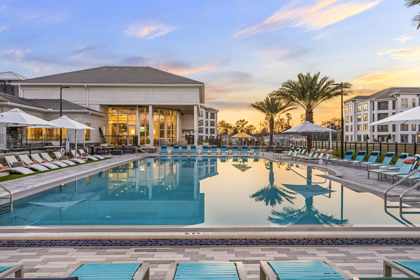 Resort-style pool with sun loungers at Sanctuary at Daytona Apartments