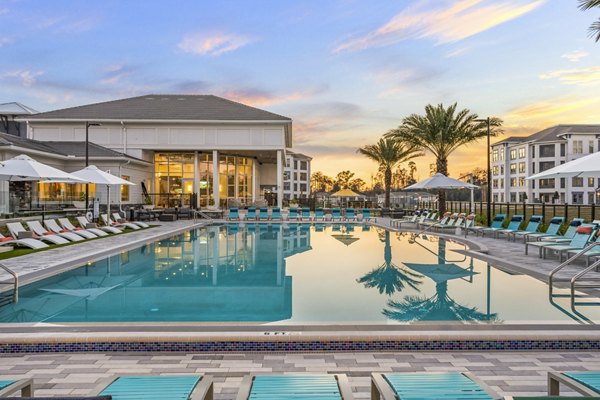 Resort-style pool with sun loungers at Sanctuary at Daytona Apartments