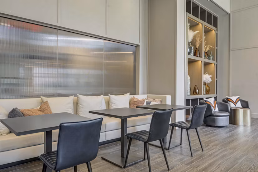 Clubhouse featuring modern design and ample seating at The Ian Apartments luxury living complex