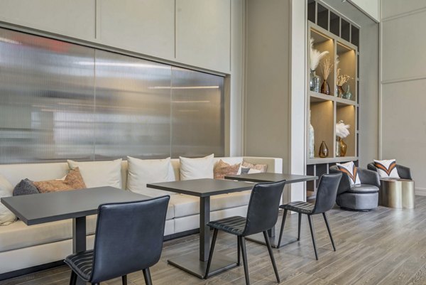 Clubhouse featuring modern design and ample seating at The Ian Apartments luxury living complex
