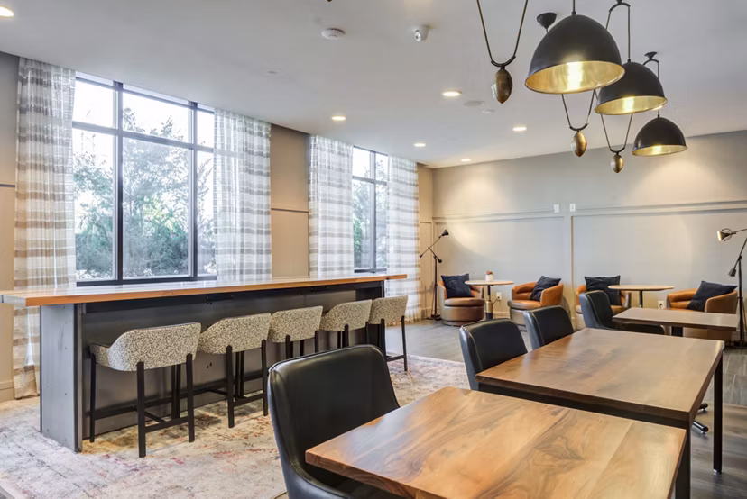 Clubhouse lounge featuring modern decor and cozy seating at The Ian Apartments, perfect for relaxation and socializing