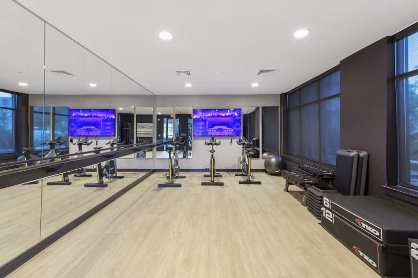 Yoga/spin studio with modern equipment at The Ian Apartments featuring wellness amenities