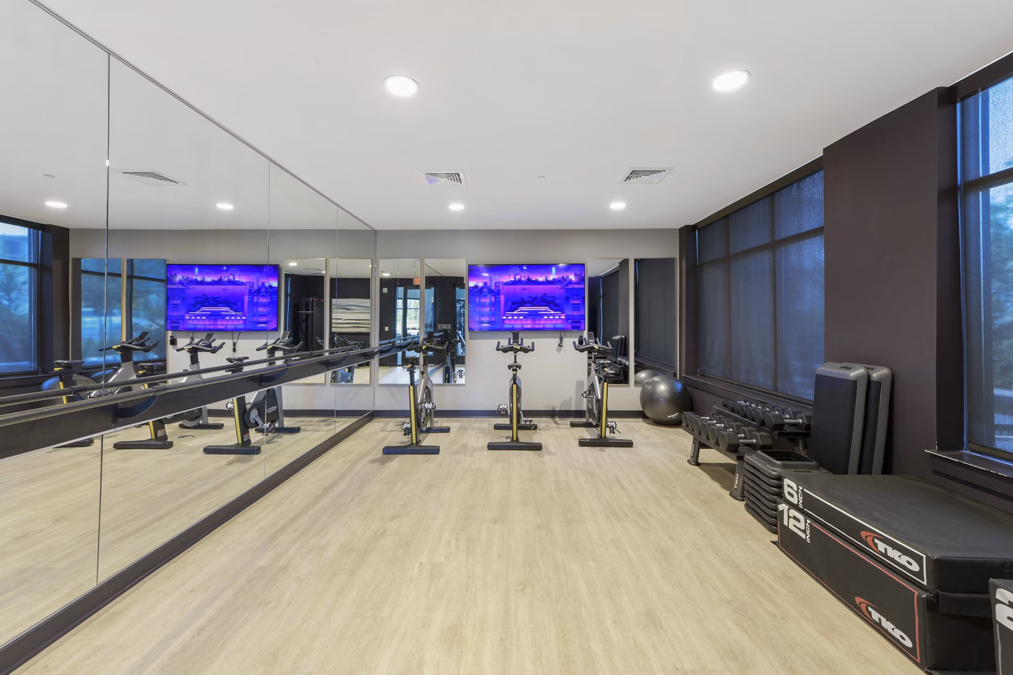 Yoga/spin studio with modern equipment at The Ian Apartments featuring wellness amenities