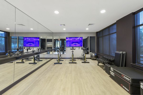 Yoga/spin studio with modern equipment at The Ian Apartments featuring wellness amenities